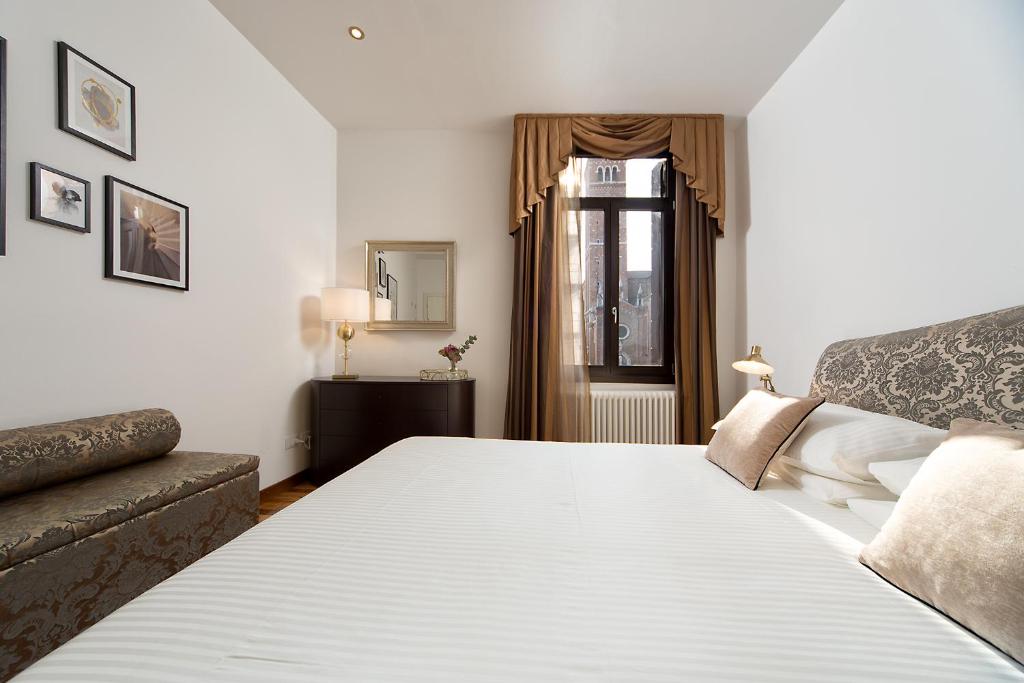 Posteľ alebo postele v izbe v ubytovaní Suite Veronica & Maison Laguna