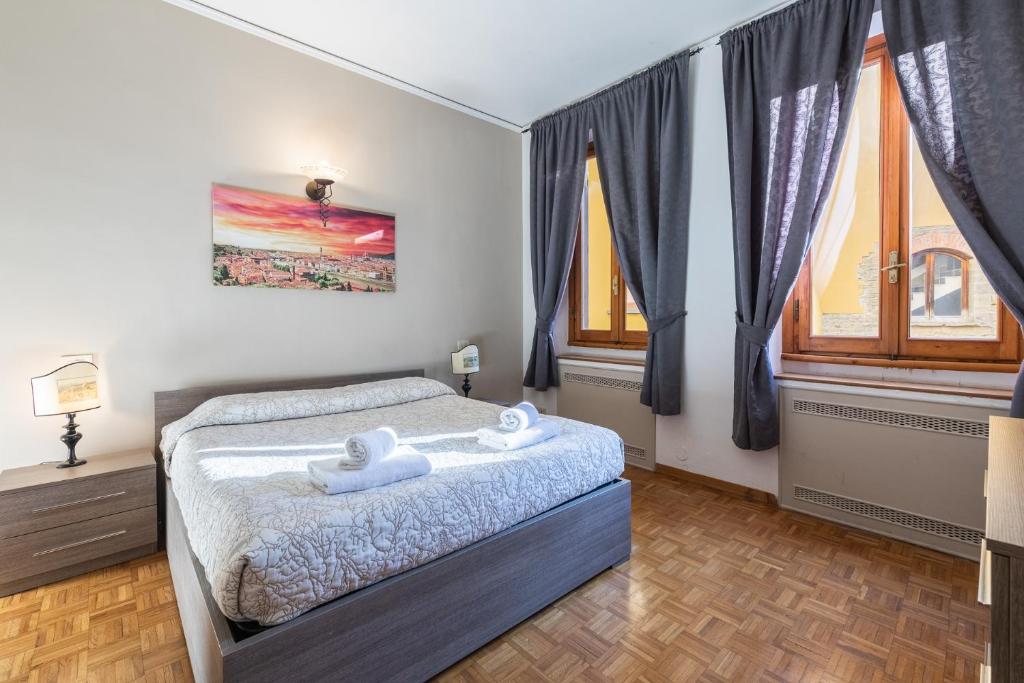 a bedroom with a bed with two towels on it at Firenze Rentals Ponte Vecchio Flat in Florence