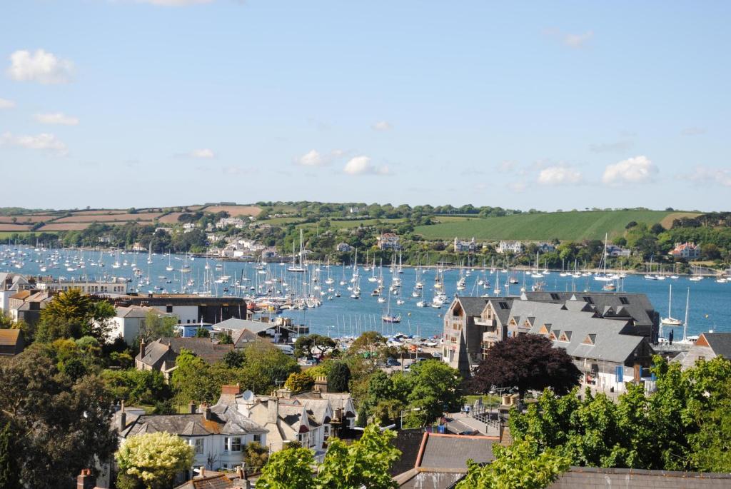 a town with a harbor with boats in the water at Highcliffe in Falmouth
