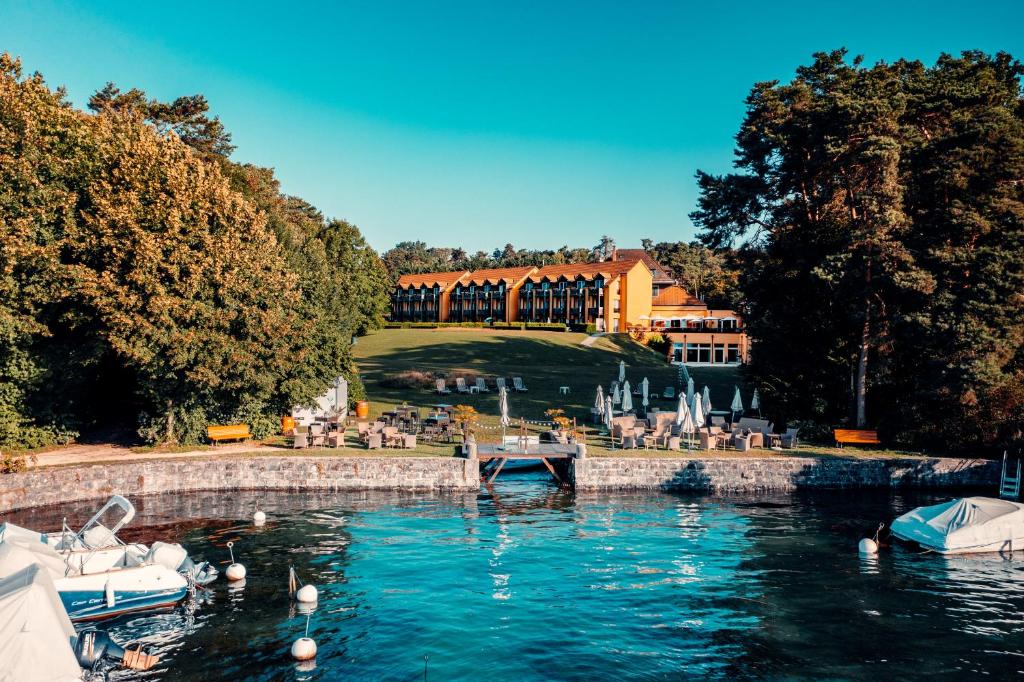 a view of a resort with a body of water at Hotel La Barcarolle in Prangins