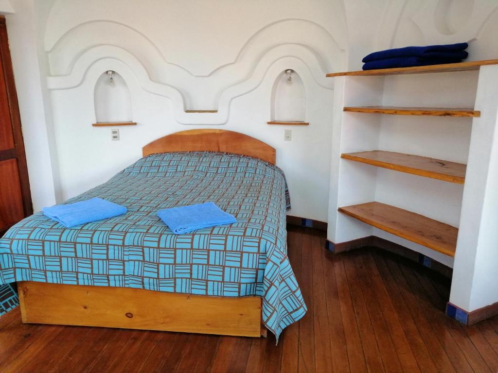 Postel nebo postele na pokoji v ubytování Hostal Las Olas