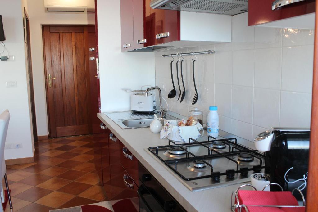 a kitchen with a stove and a counter top at Villa Sofia in Taormina