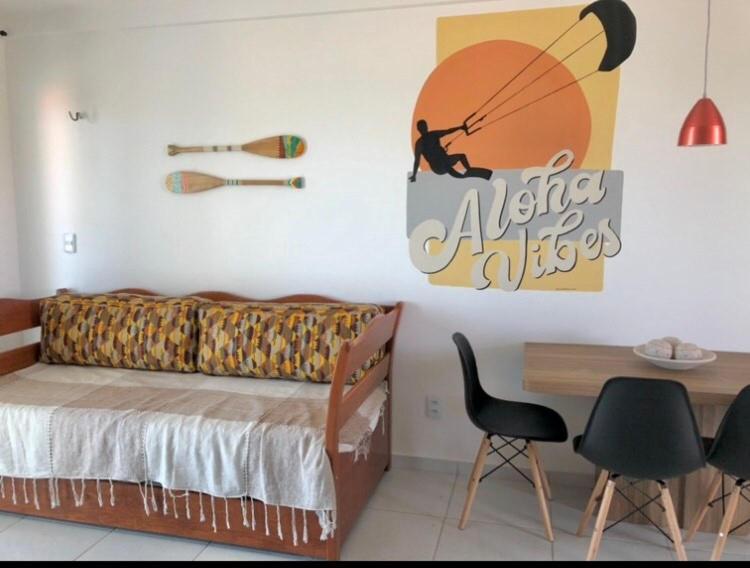 a bedroom with a bed and a table and chairs at Aloha Vibes Ap Cumbuco - Green Club in Cumbuco