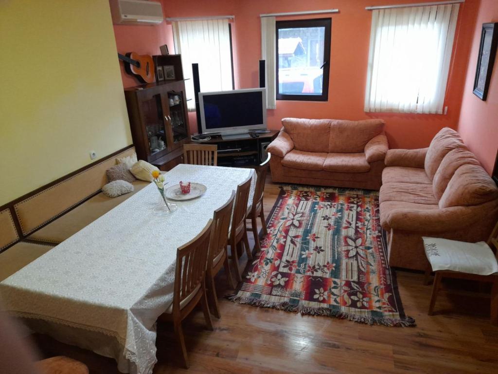 a living room with a table and a couch at Гергана in Veliko Tŭrnovo