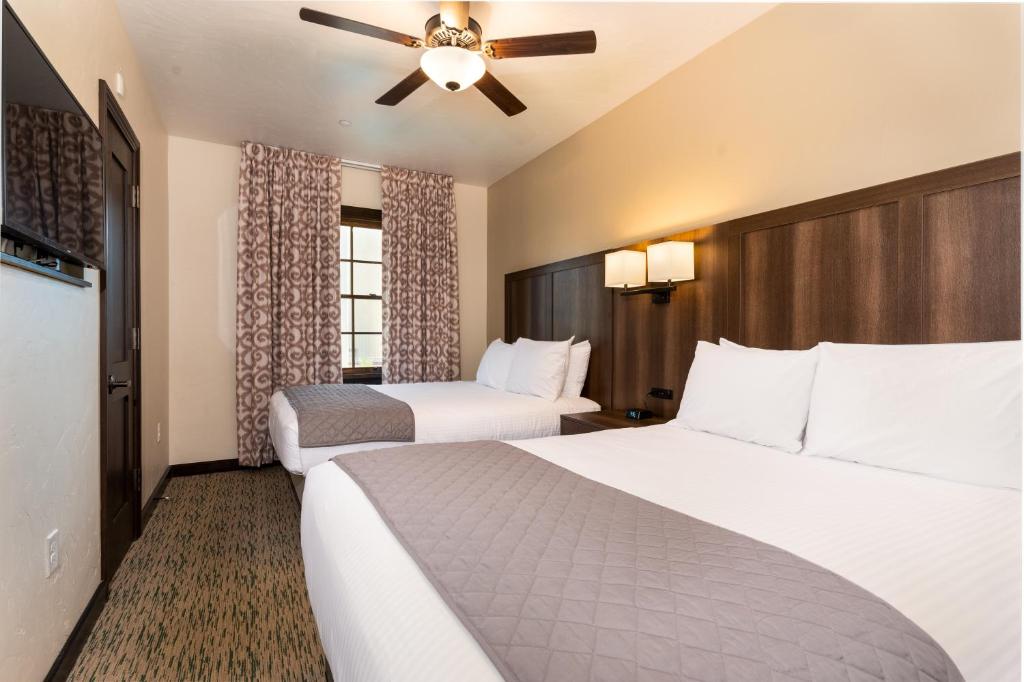 a hotel room with two beds and a ceiling fan at The Ranch At Death Valley in Indian Village