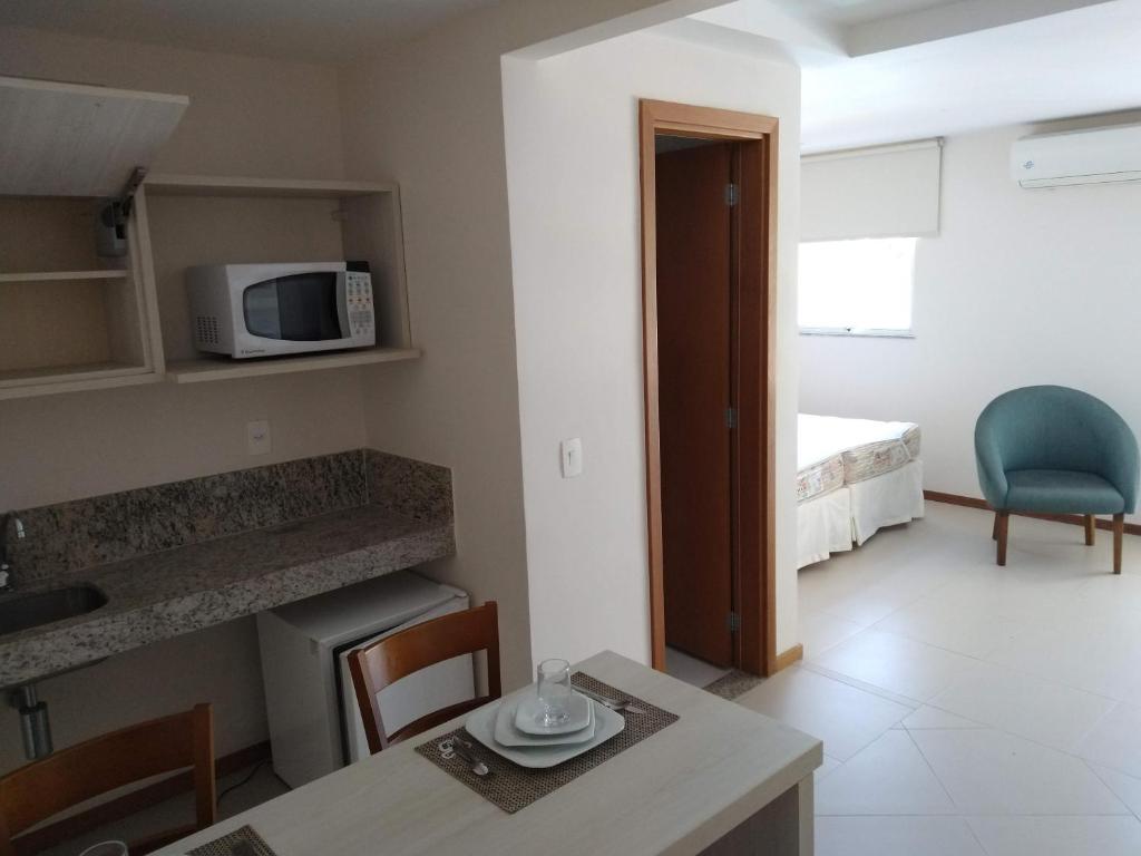 a small room with a table and a microwave at PORTO MARINA MONT BLANC RESORT in Mangaratiba