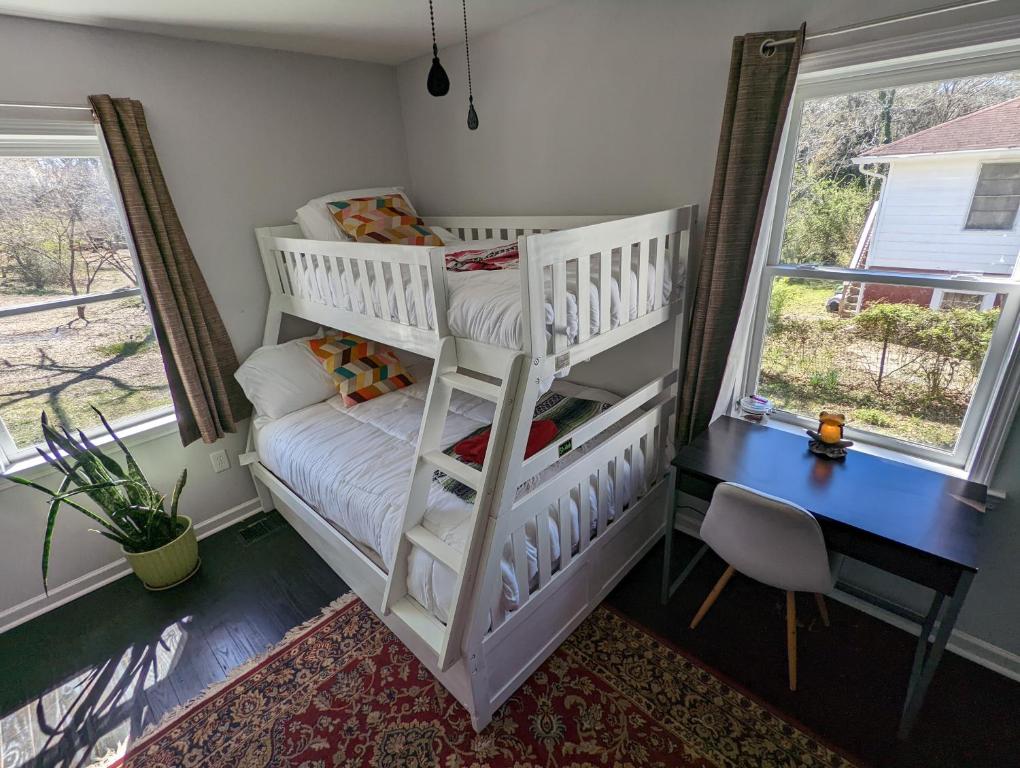 a white bunk bed in a room with two windows at eKstasis Hostel & Urban Farm in Atlanta