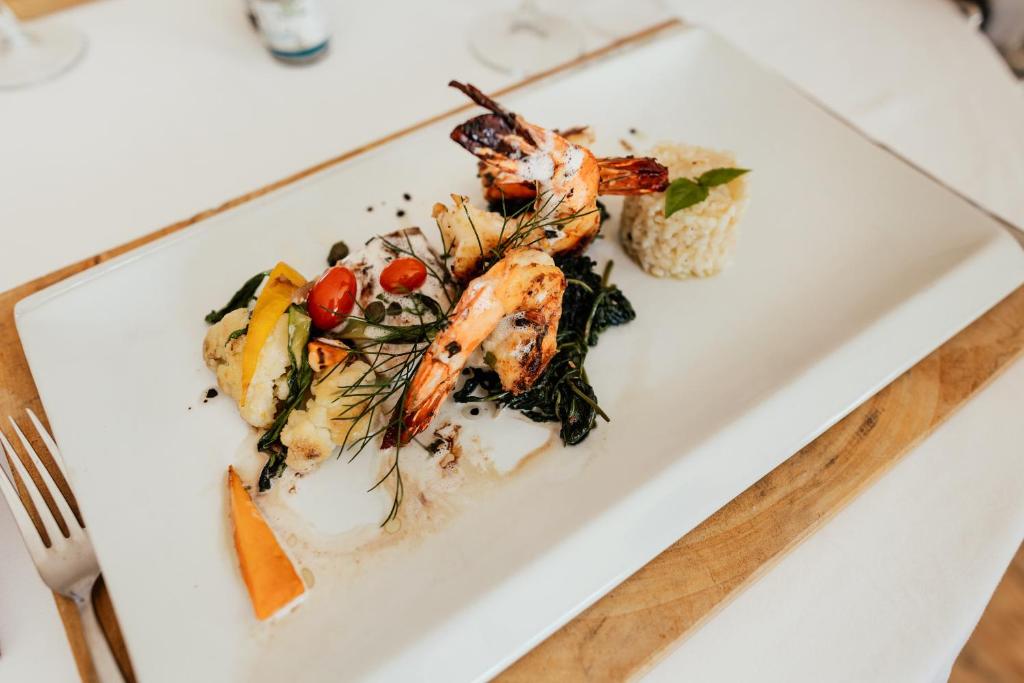 a white plate with food on a table at Gold Zanzibar Beach House & Spa in Kendwa