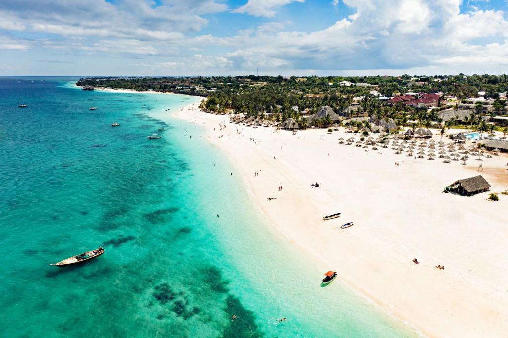 an aerial view of a beach with people and umbrellas at Gold Zanzibar Beach House & Spa in Kendwa