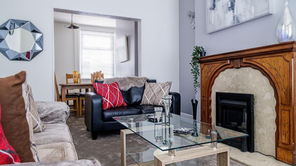 a living room with a couch and a fireplace at Hibbert Galore in Barrow in Furness