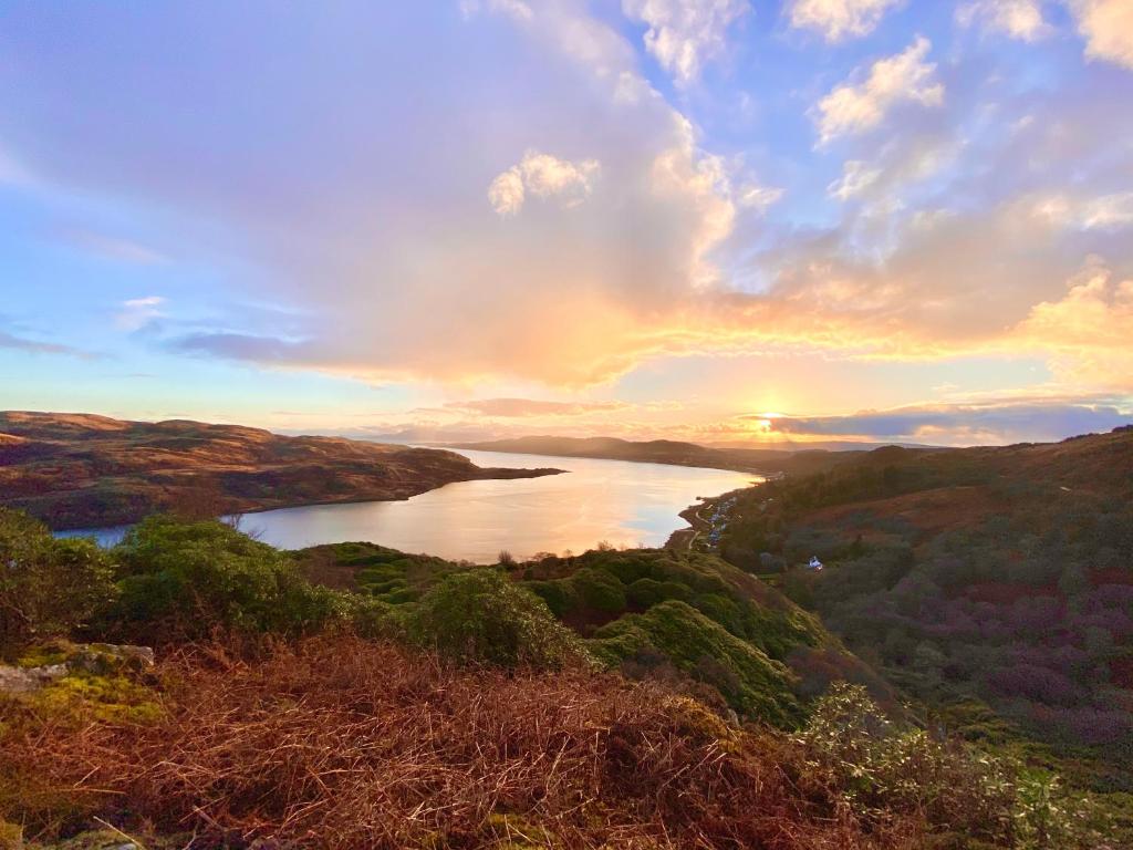 a view of a river with the sunset in the background at Upper Villa, Tighnabruiach, Argyll & Bute in Tighnabruaich