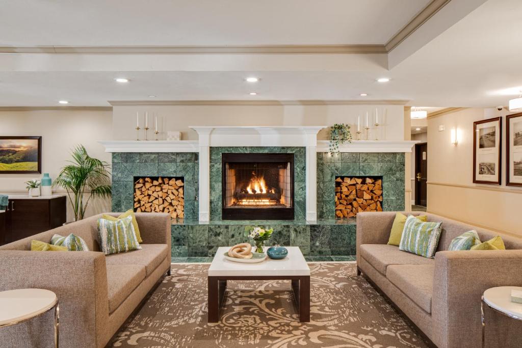 a living room with two couches and a fireplace at Ayres Hotel Corona East in Corona