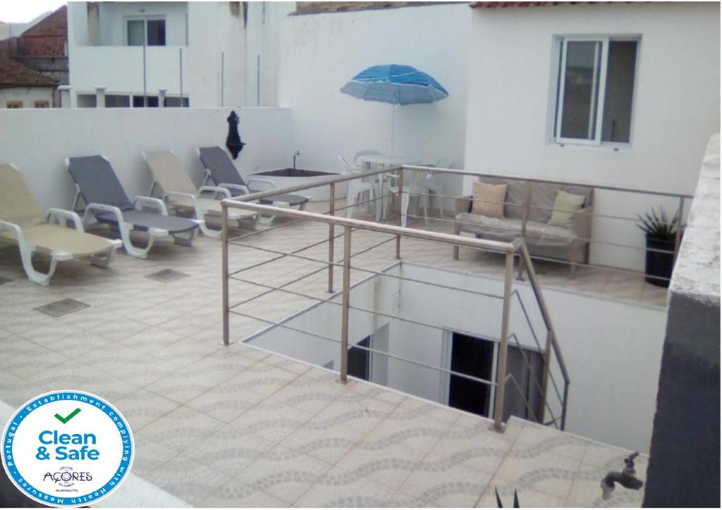 balcone con divano e ombrellone di Casa Central a Ponta Delgada
