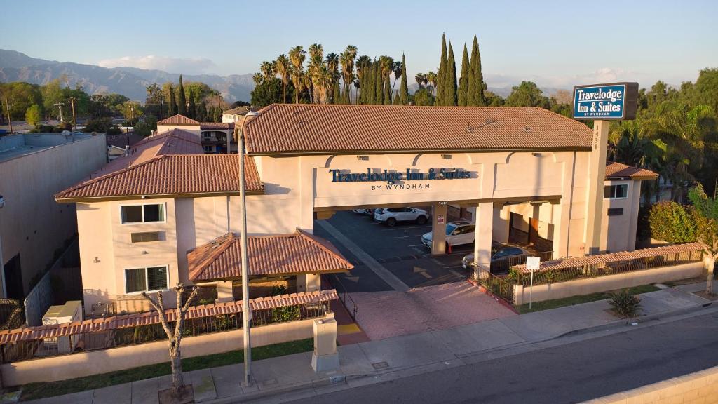 an overhead view of a building with a parking lot at Travelodge Inn & Suites by Wyndham West Covina in West Covina