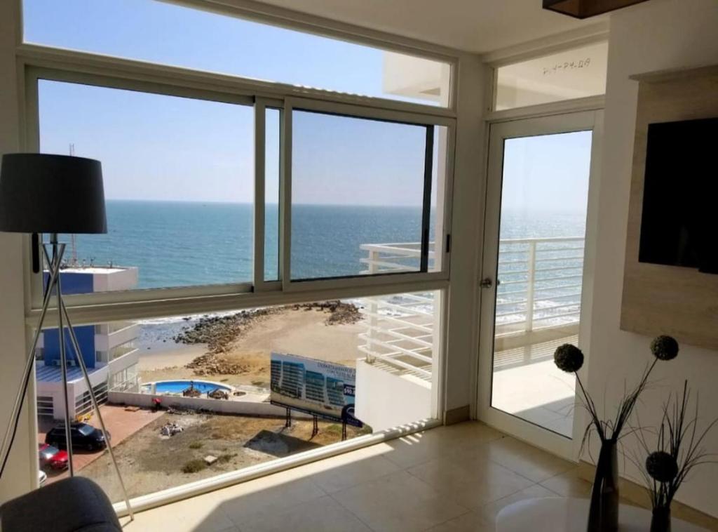 a living room with a view of the ocean at OCEAN CLUB 401 MEDITERRANEA in Playas