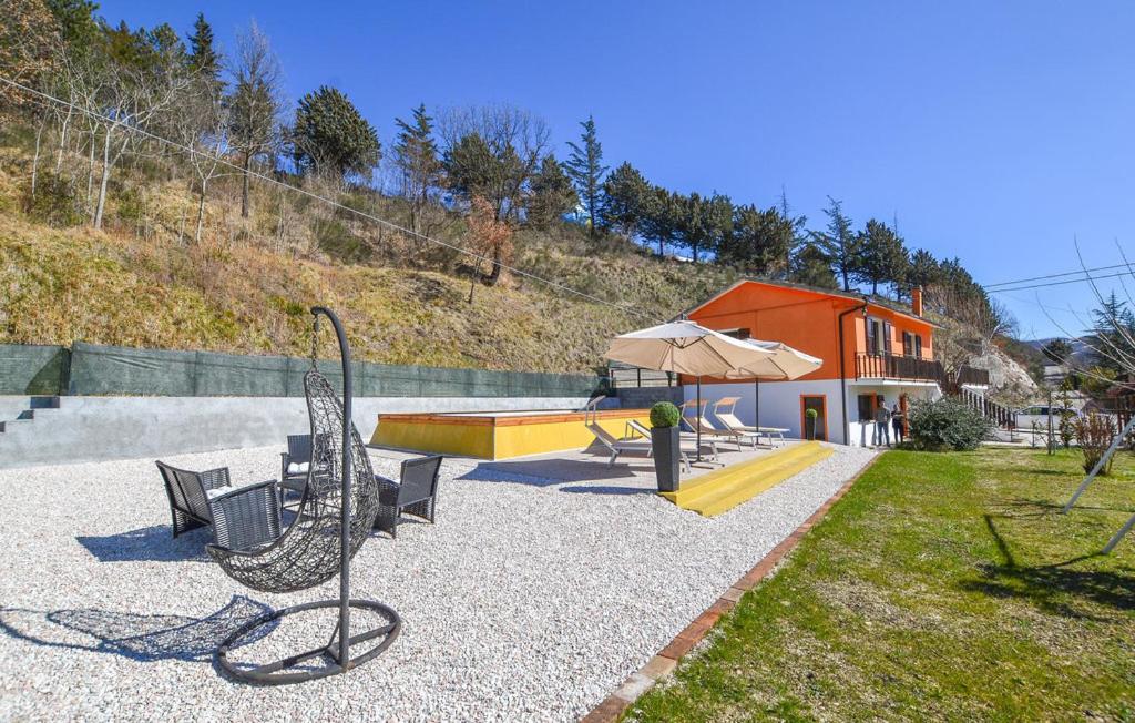 a park with a playground with a bench and an umbrella at Casa di Cristian in Pian di Mulino