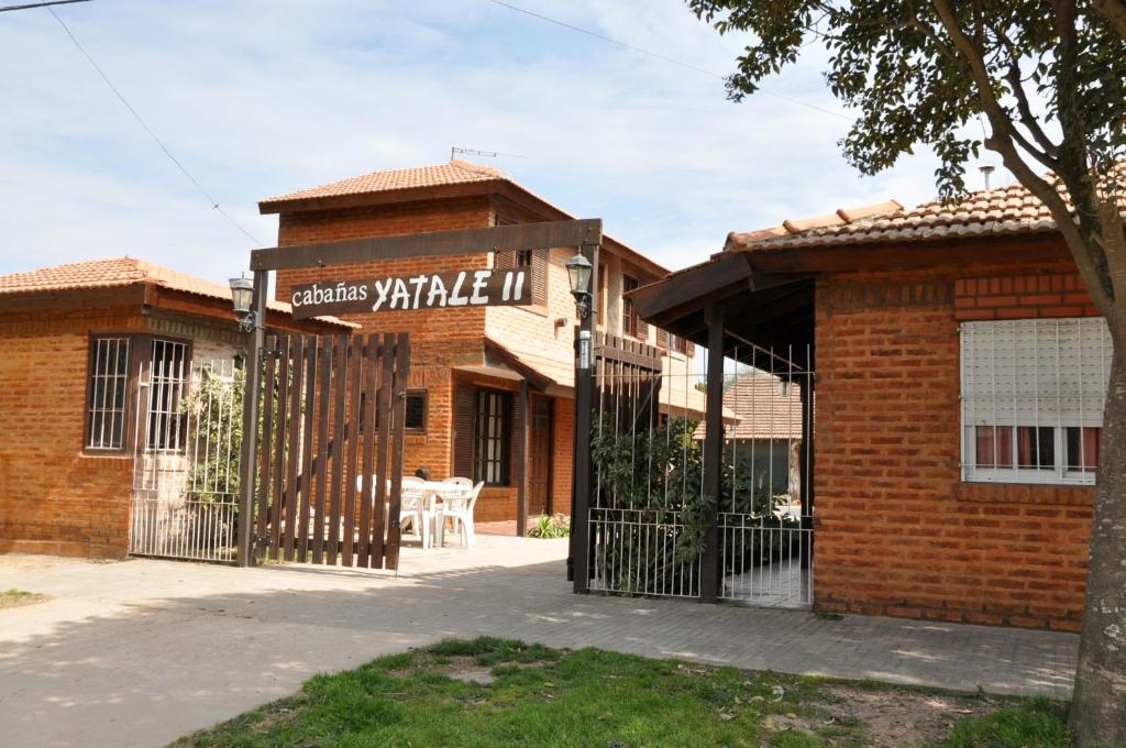 a brick building with a gate in front of it at Yatale II in Chascomús