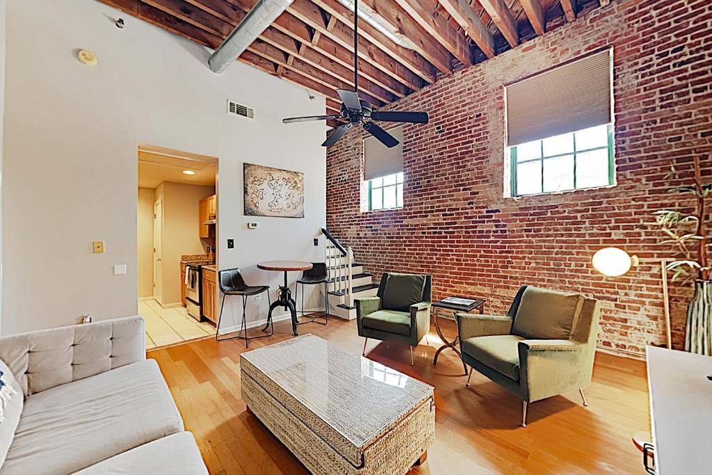 a living room with a brick wall at The Basecamp in Savannah