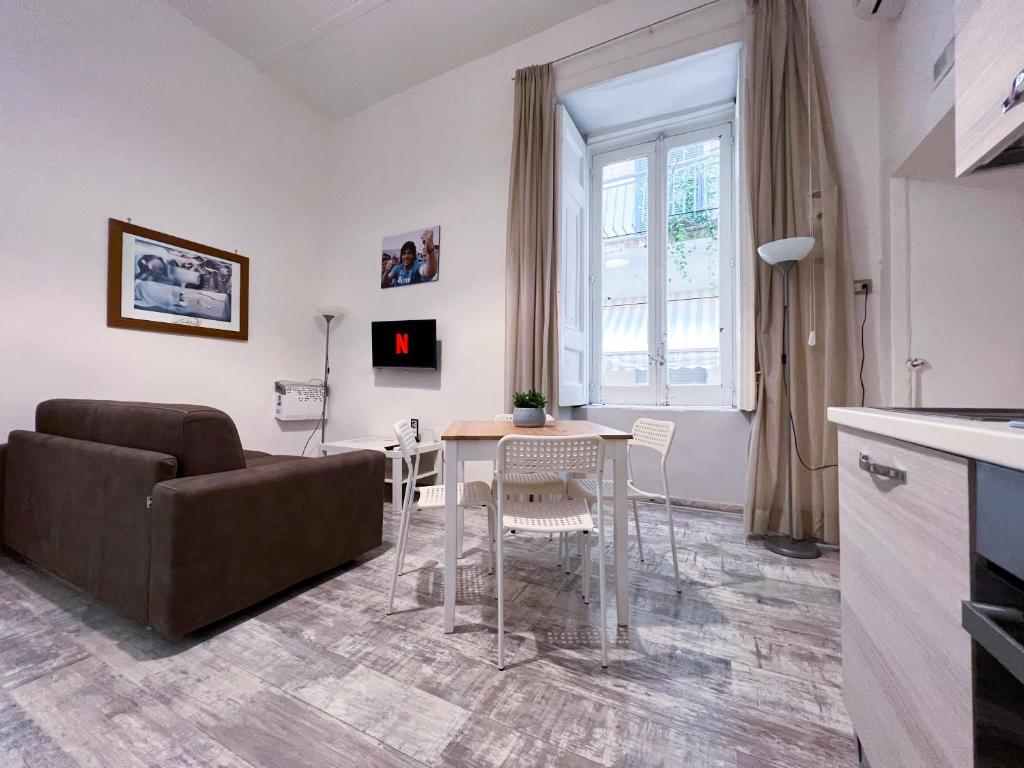 a living room with a couch and a table at CASA MARTINO FORMALE in Naples