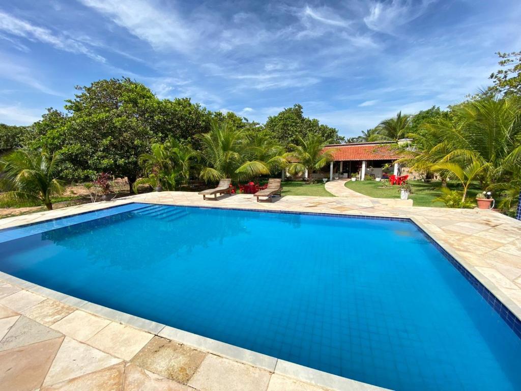a swimming pool in front of a villa at Sitio das Amélias in Jijoca de Jericoacoara