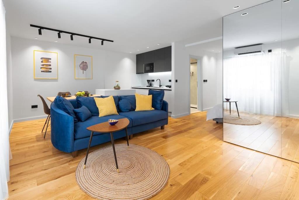 a living room with a blue couch and a table at Apartment Old Town Finesse in Dubrovnik