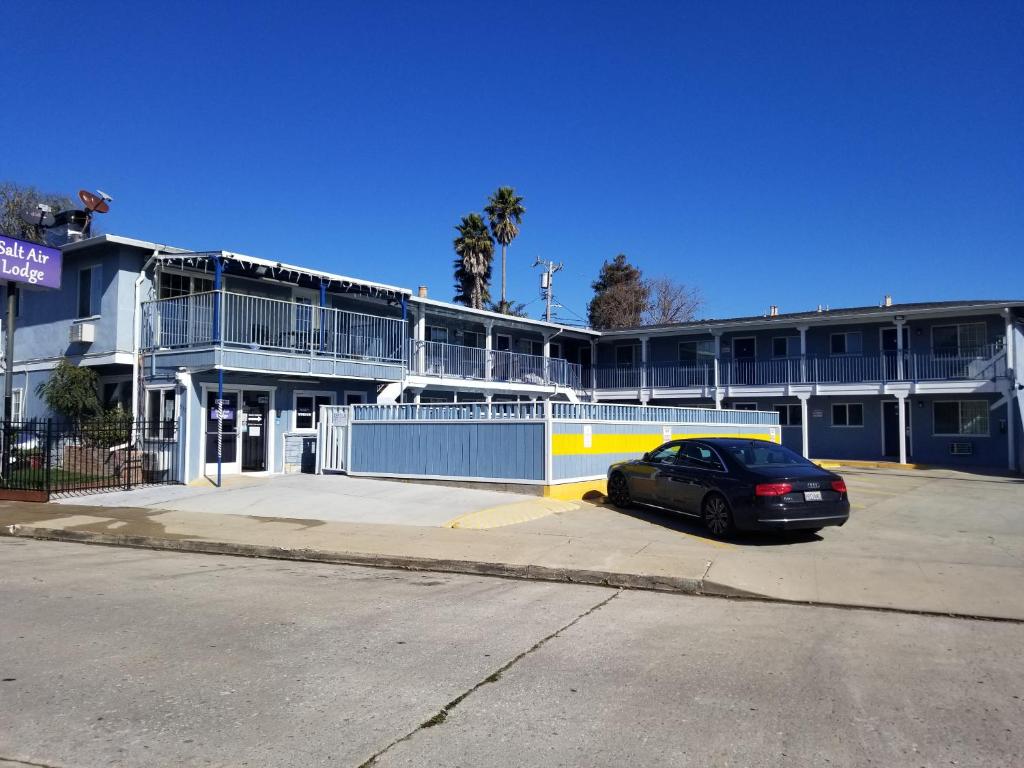 a car parked in a parking lot in front of a building at Salt Air Lodge in Santa Cruz
