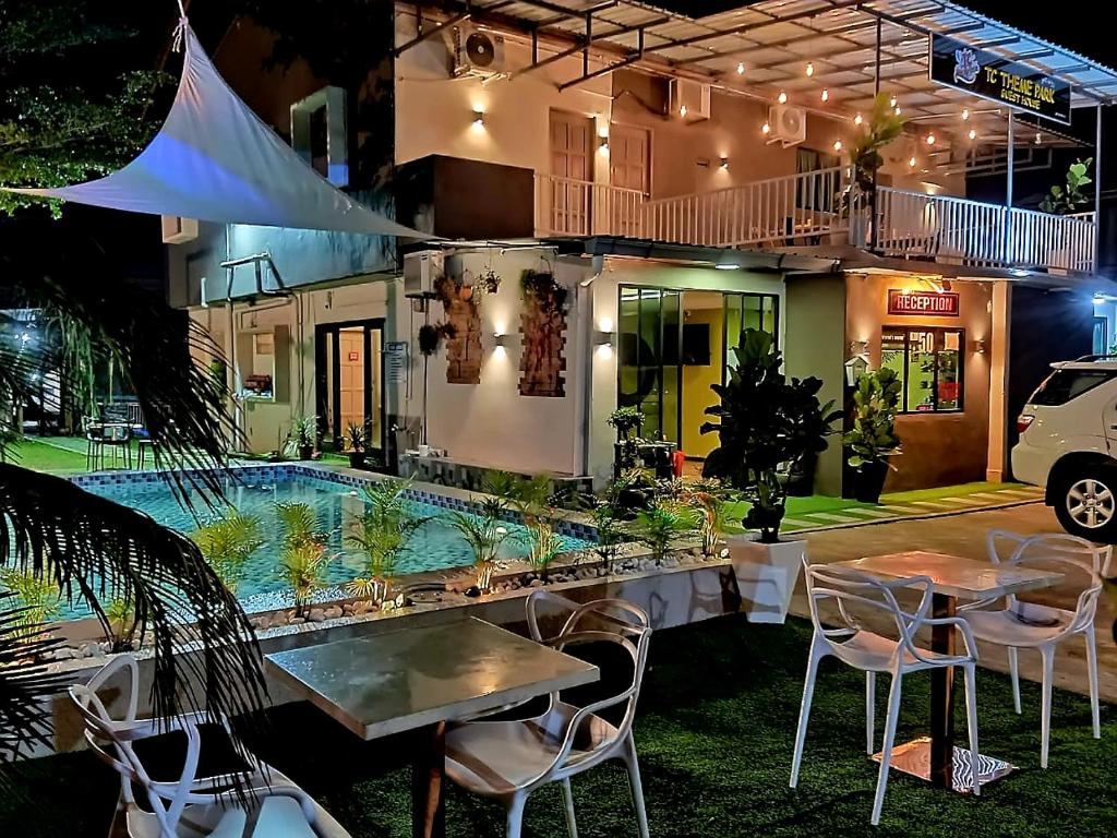 a resort with a swimming pool at night at Tc theme park Guest house in Kuantan