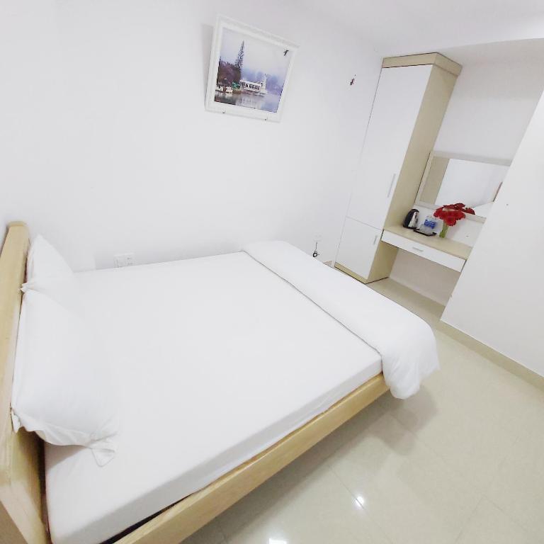 Postel nebo postele na pokoji v ubytování Daisy Dalat House