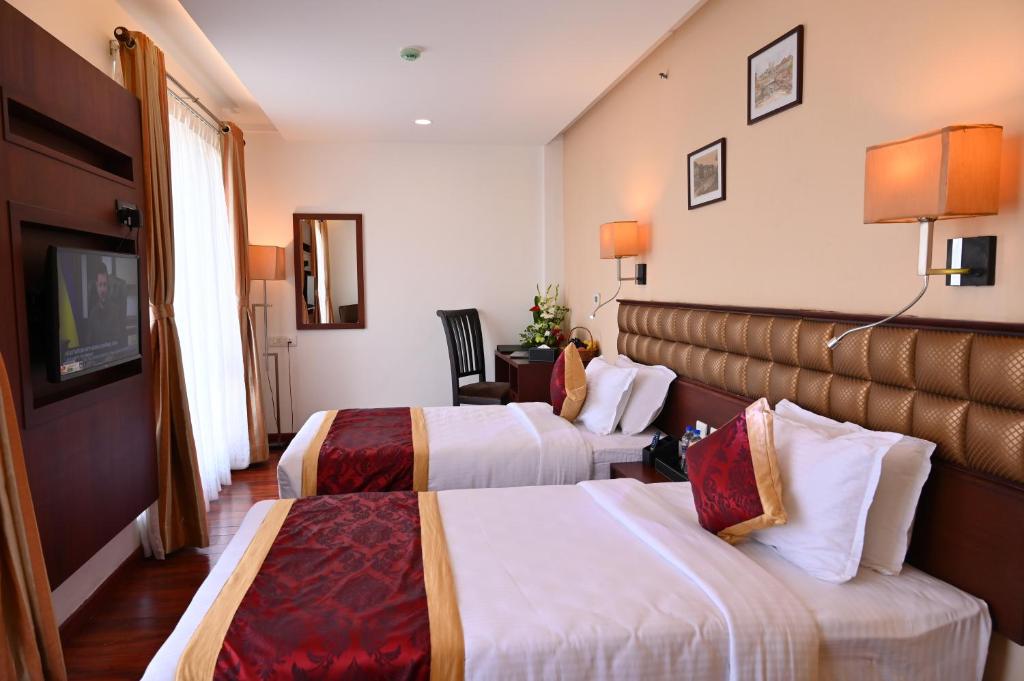 Postel nebo postele na pokoji v ubytování Raaj Bhaavan Clarks Inn Chennai