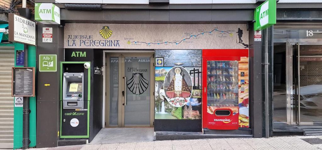 a store front of a store with the door open at Albergue Turístico La Peregrina in Oviedo