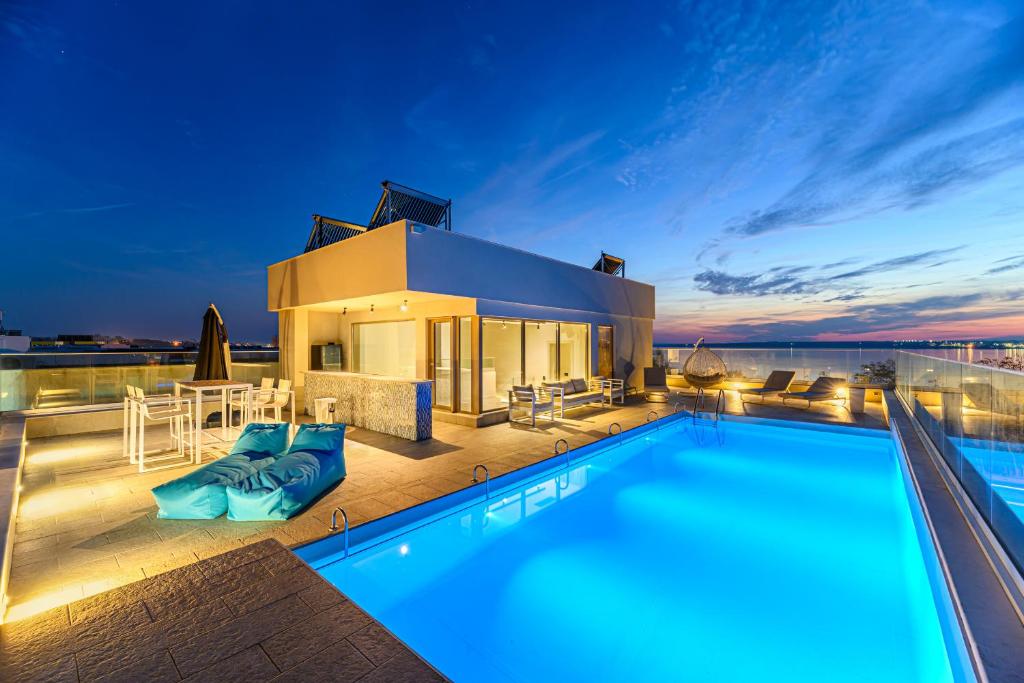 a villa with a swimming pool and a house at Seascape Villa in Eforie Sud