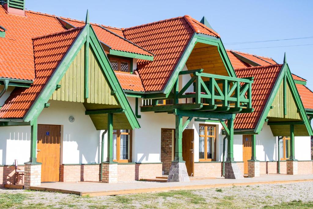 a row of houses with orange roofs at Stanica Żeglarska Otago in Pisz