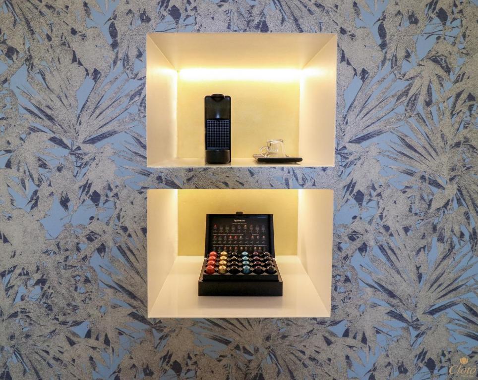a room with a soap dispenser on a wall at Double A Luxury Room in Olbia