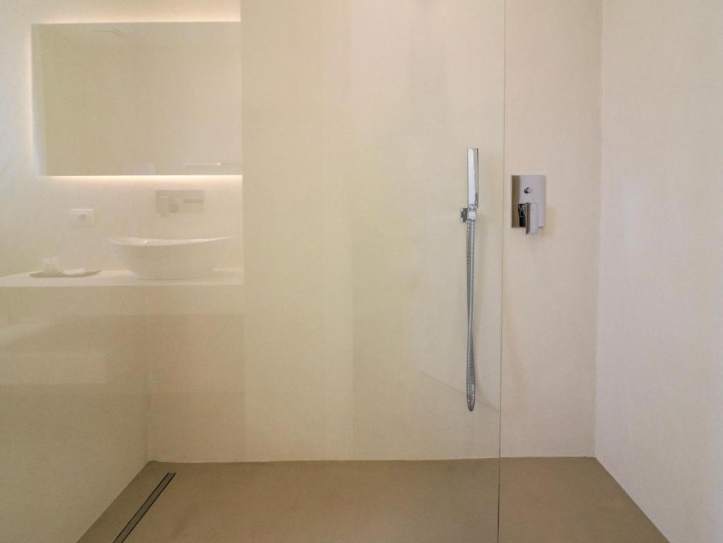a shower with a glass door in a bathroom at Double A Luxury Room in Olbia