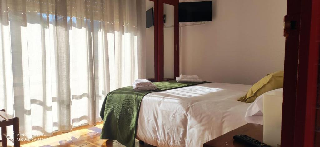 Ένα ή περισσότερα κρεβάτια σε δωμάτιο στο Posada Ojedo Los Ñeros