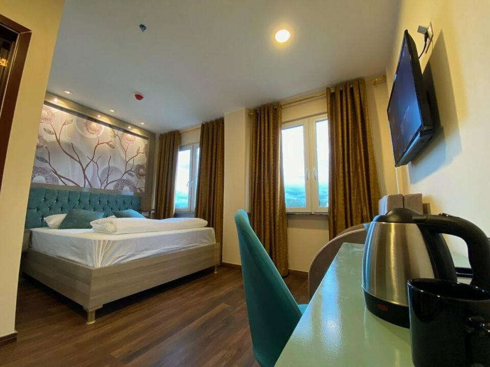 ベルリンにあるHotel Grand Innのベッドとテレビがあるホテルの部屋