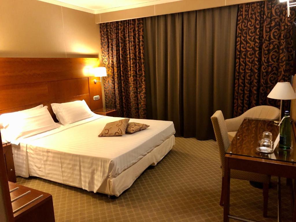 Postel nebo postele na pokoji v ubytování Hotel Liola'