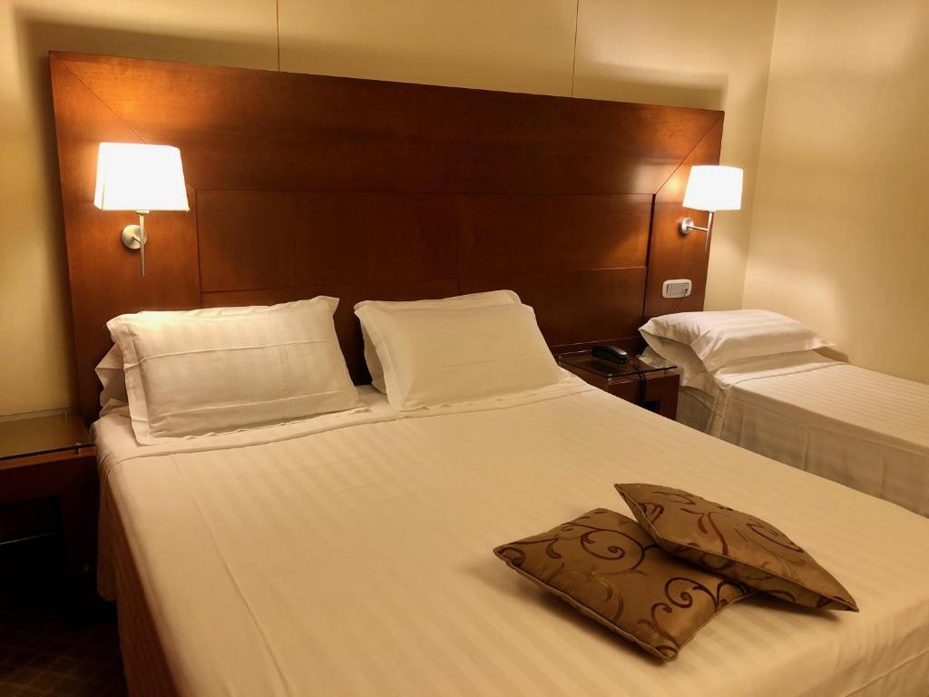 Postel nebo postele na pokoji v ubytování Hotel Liola'
