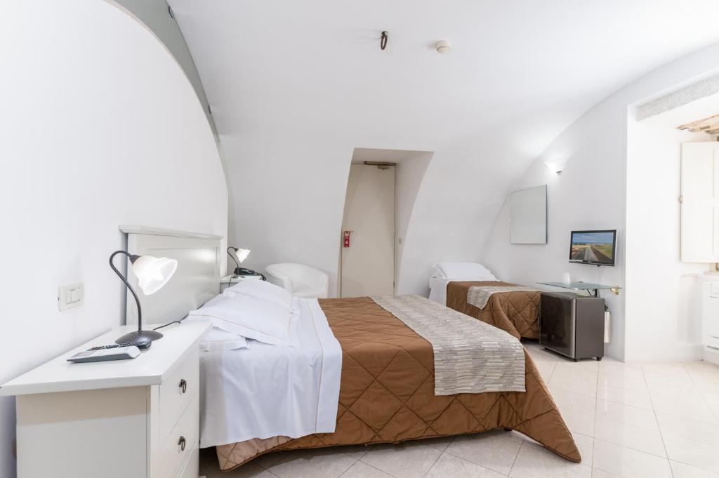 Postel nebo postele na pokoji v ubytování Hotel La Terra