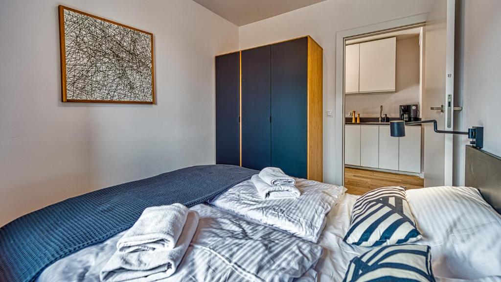 Posteľ alebo postele v izbe v ubytovaní Apartament Triventi 98 z Widokiem- 5D Apartamenty