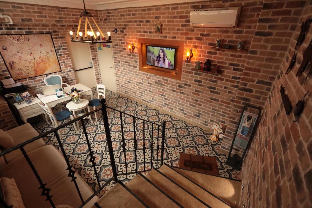 a staircase in a room with a brick wall at White Pearl Apart Hotel in Istanbul