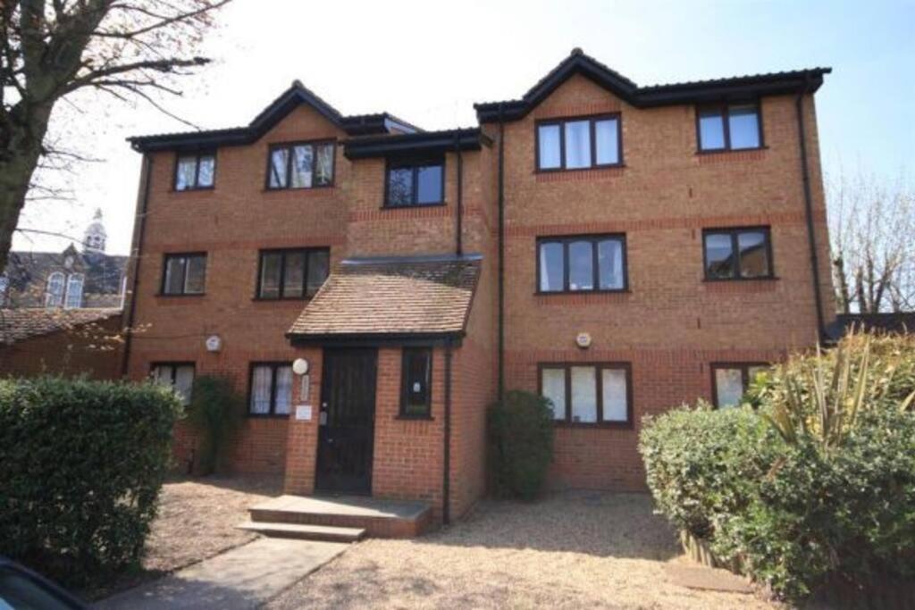 a large brick building with a door in front of it at Mornington Place in London