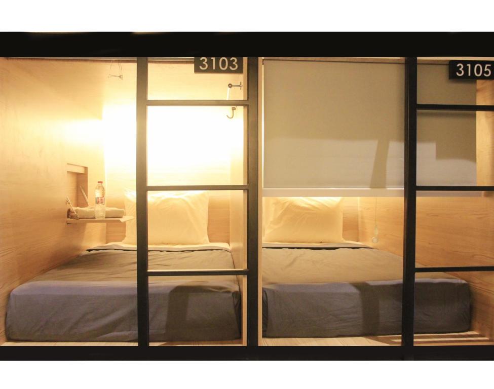 a bedroom with a bed inside of a room at My Studio Hotel Juanda Airport Surabaya in Sedati