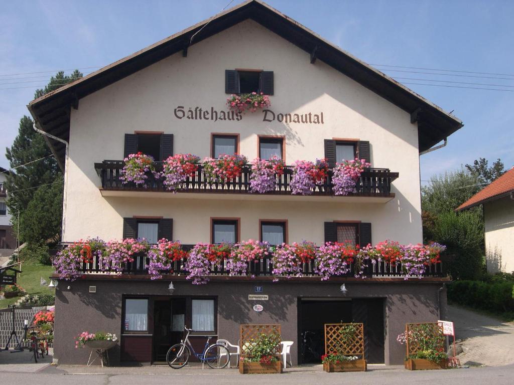 a building with flower boxes on the balconies at Gästehaus Donautal in Vichtenstein