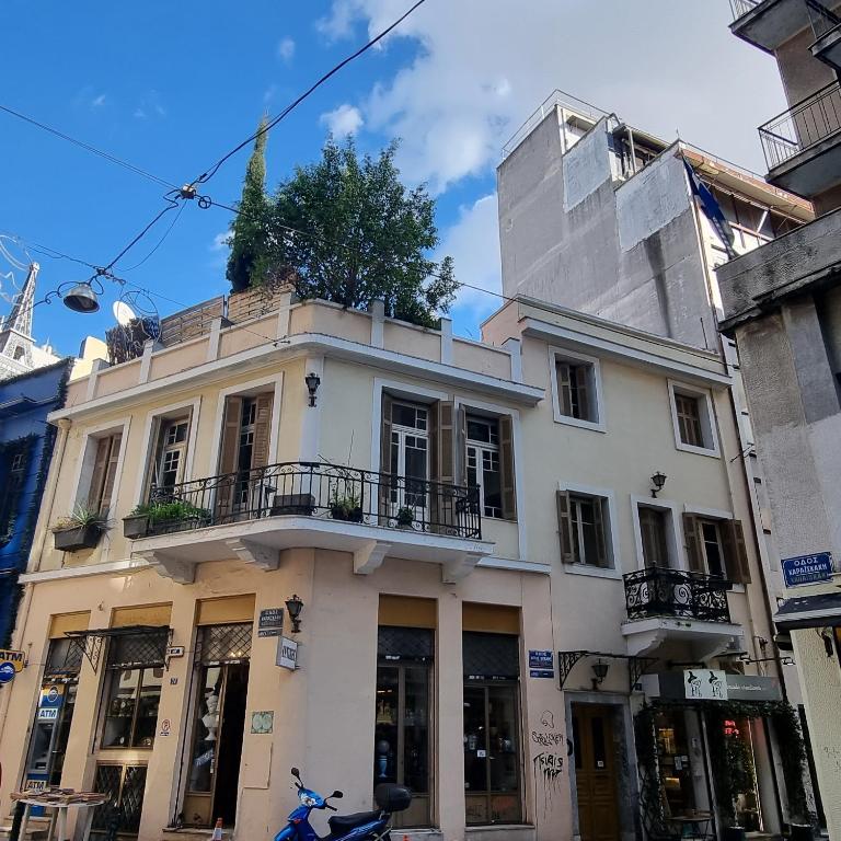 a white building with a tree on top of it at athensvintage in Athens