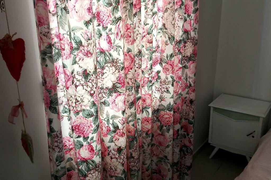 a curtain with flowers on it in a bedroom at Paris house 3 in Patra