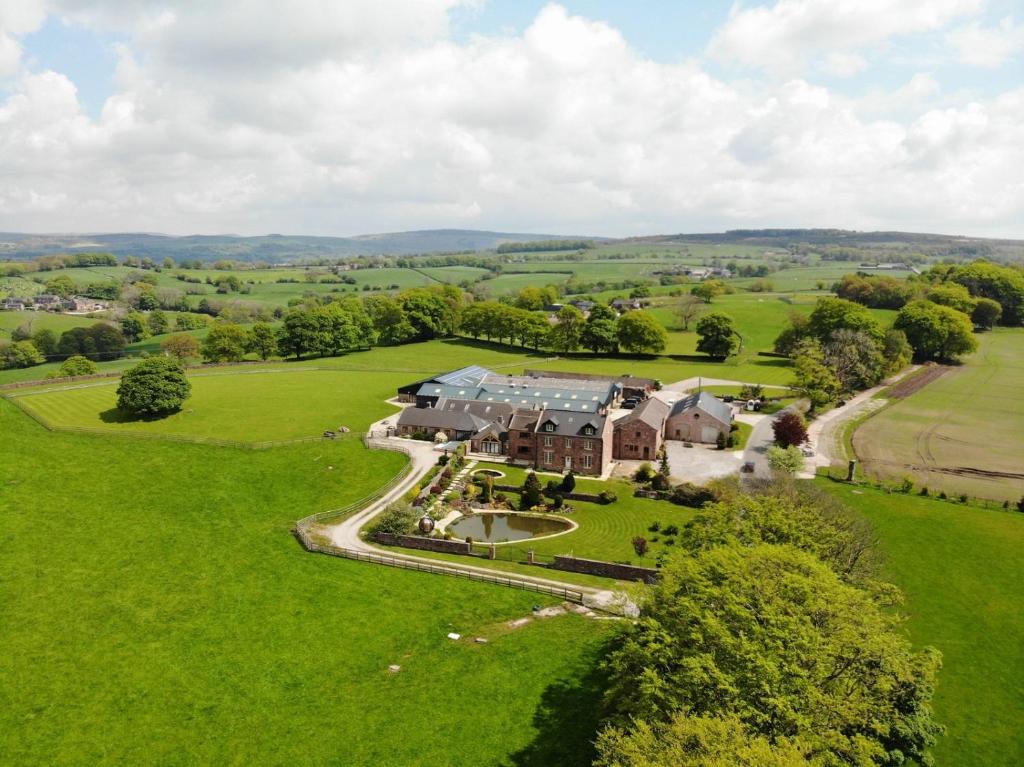 an aerial view of a large house in a field at Heaton House Farm in Macclesfield