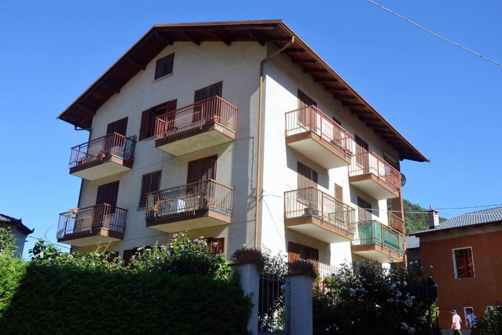a white building with balconies on the side of it at One bedroom appartement with balcony and wifi at Monterosso Grana in Levata
