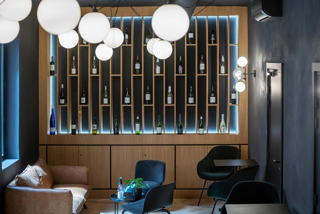a lobby with a couch and chairs and lights at Hôtel Tandem - Boutique Hôtel in Strasbourg