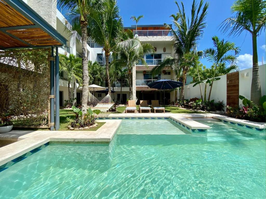 a swimming pool in front of a house at Casa Elda in Tulum